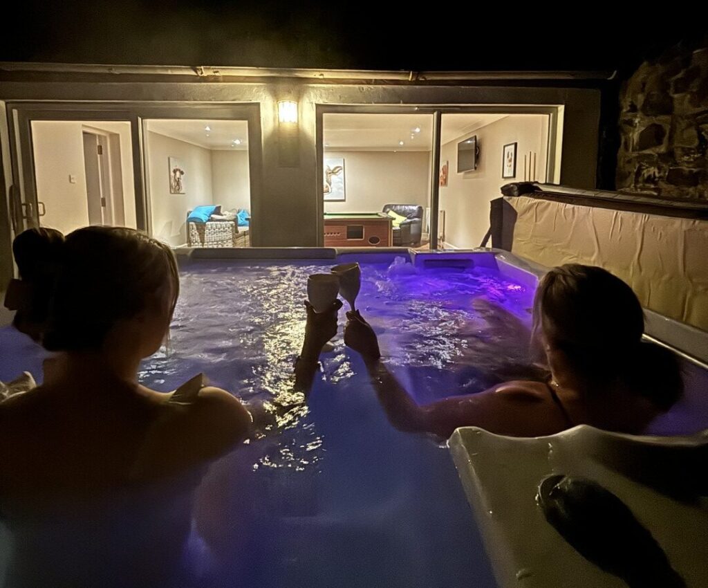 Private hot tun under the night sky at Balmeadowside Farmhouse, perfect for relaxing winter breaks in Scotland